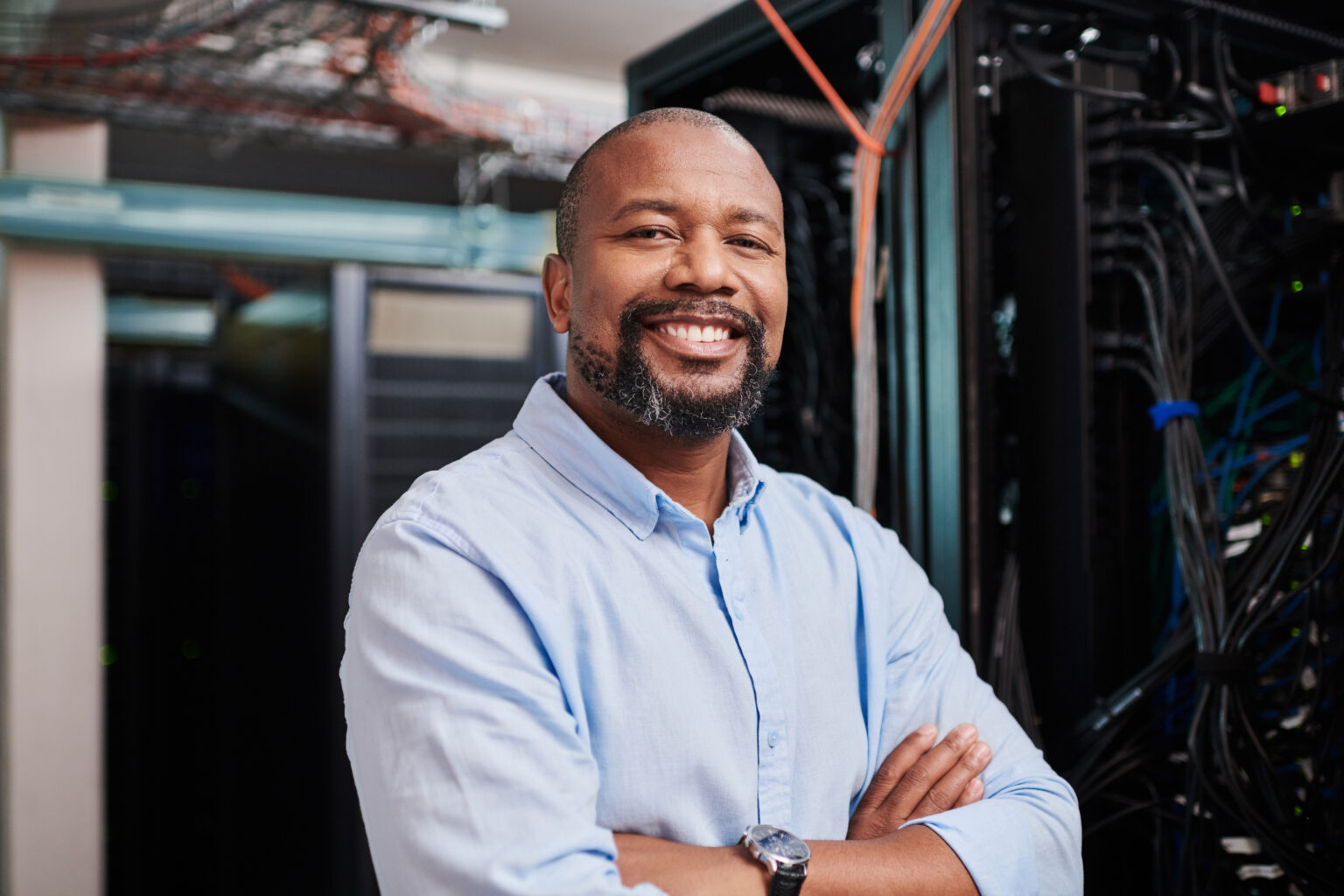 Portrait of a mature man standing with his arms crossed in a server room
