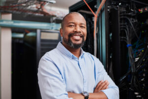 Portrait of a mature man standing with his arms crossed in a server room